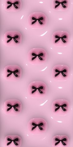 an abstract pink background with black bows and hearts on the bottom, as well as two rows of smaller bow - shaped buttons