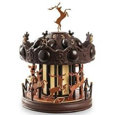 a chocolate carousel with reindeers on the top and an antelope atop it