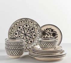 an assortment of black and white dinnerware