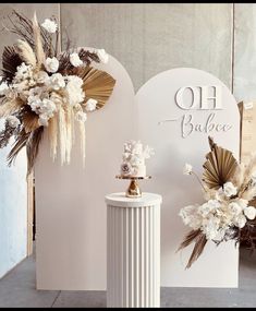 two white vases with flowers on them next to a sign that says oh balance