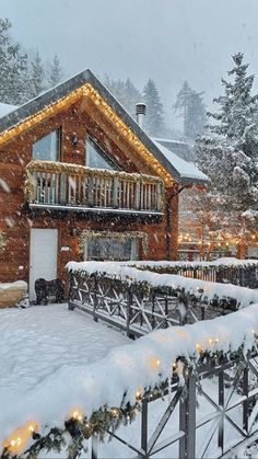 a house covered in snow with christmas lights