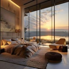 a bedroom with a large window overlooking the water at sunset or sunrise, and an ottoman on the floor in front of the bed