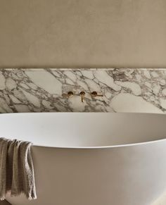 a large white bath tub sitting next to a wall