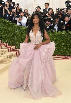 an image of a woman in a pink dress posing for the camera with cameras around her