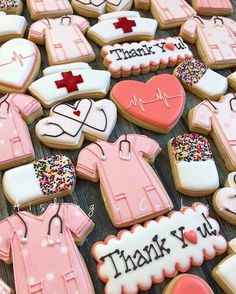 decorated cookies are arranged on a table with thank you written on the ones in pink and white