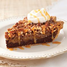 a slice of pecan pie on a white plate with caramel drizzle