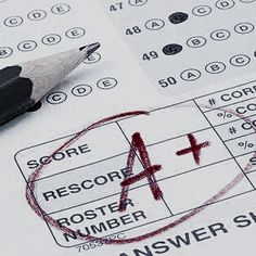 a pen sitting on top of a piece of paper next to a red cross mark