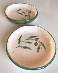 two bowls with olives painted on them