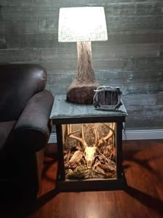 a lamp that is on top of a table with a deer head in the middle