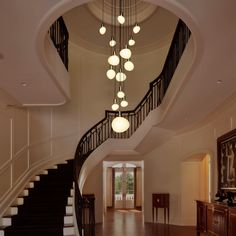 a staircase with lights hanging from it's sides