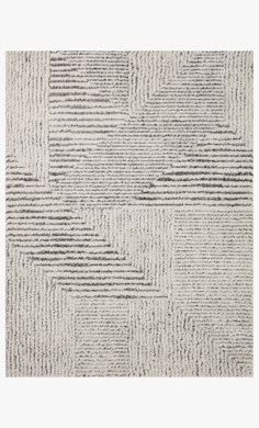 a white rug with black and grey stripes on the bottom, in an abstract pattern