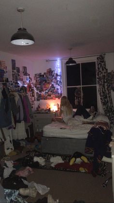 a woman sitting on top of a bed in a bedroom