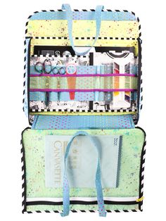 an open suitcase filled with lots of items on top of a white background and blue ribbon