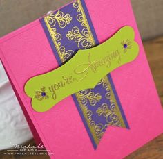 a close up of a pink and purple card