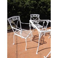 two white wrought iron patio furniture set