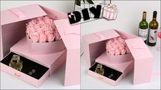 two pink boxes with roses in them sitting on a table next to bottles and wine glasses