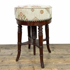 an old stool with a cushion on it