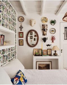 a bedroom with many plates on the wall