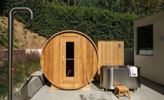 a wooden sauna is sitting outside in the sun