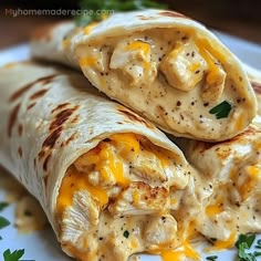 two burritos with chicken and cheese on a plate