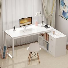 a white desk with a computer on top of it