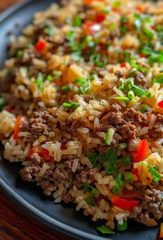 a close up of a plate of food with rice and meat on it, including carrots