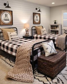 two beds in a room with black and white decor