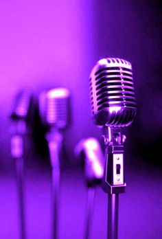 three microphones are shown in front of a purple background