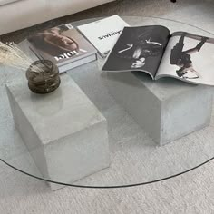 a glass table topped with books and magazines