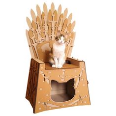 a cat sitting on top of a cardboard game of throne