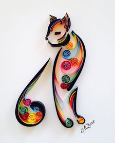 a colorful cat made out of paper on a white surface with spirals in the shape of circles