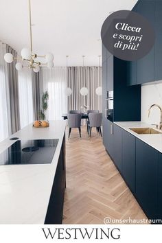 a modern kitchen with black cabinets and white counter tops is featured in the westwing magazine