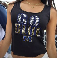 a close up of a person wearing a shirt with the words go blue on it