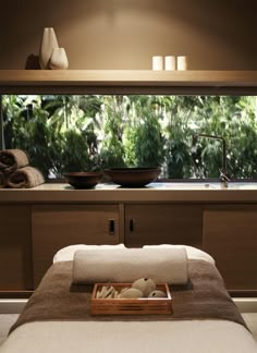 a spa room with towels on the bed