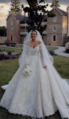 a woman in a wedding dress posing for the camera