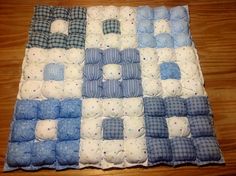 a blue and white patchwork baby quilt