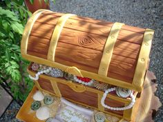 a wooden trunk that is sitting on top of a tree stump with buttons and chains around it