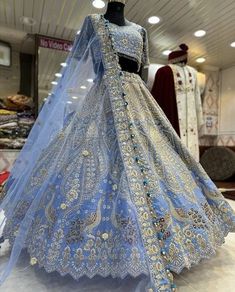 a blue bridal gown on display in a store