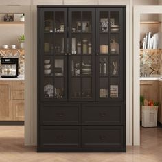 a black cabinet with glass doors in the middle of a wooden floored kitchen area