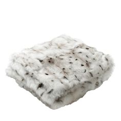 a white fur blanket with black spots on it