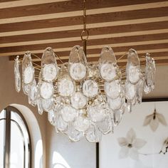 a chandelier hanging from the ceiling in a living room