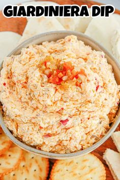 a bowl filled with dip surrounded by crackers