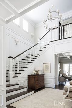 a white staircase in a house with wood flooring and rug on the carpeted floor