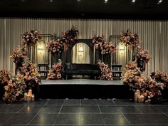 a stage set up with flowers and candles