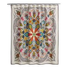 a colorful shower curtain hanging on the side of a white wall with an ornate design