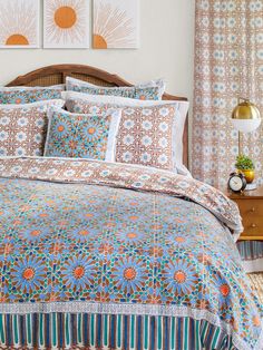 a bed with blue and orange bedspread in a bedroom