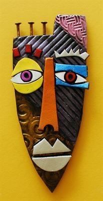 a wooden mask with two eyes and three spikes on it's head, against a yellow background