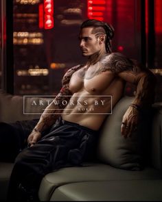 a man with tattoos sitting on a couch