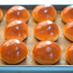 freshly baked sweet rolls sitting on a baking sheet ready to be baked in the oven