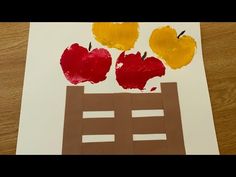 an art project made with paper and apples